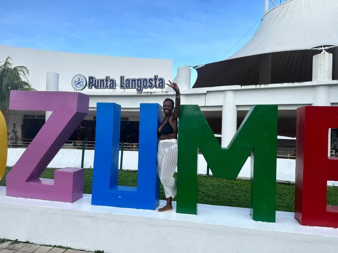 Arliee posing inside the colorful Cozumel letters