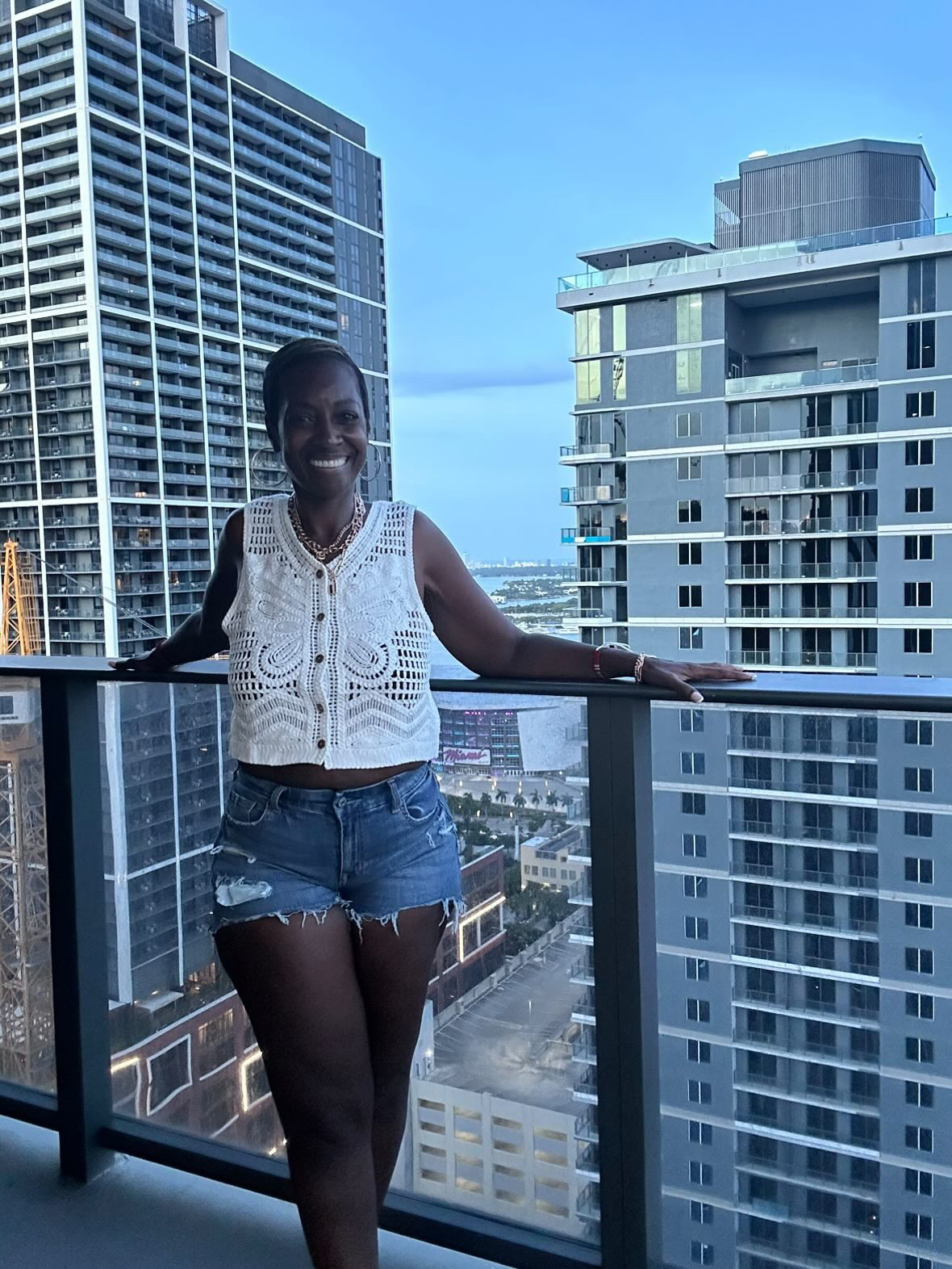 Arliee on a Brickell balcony at blue hour